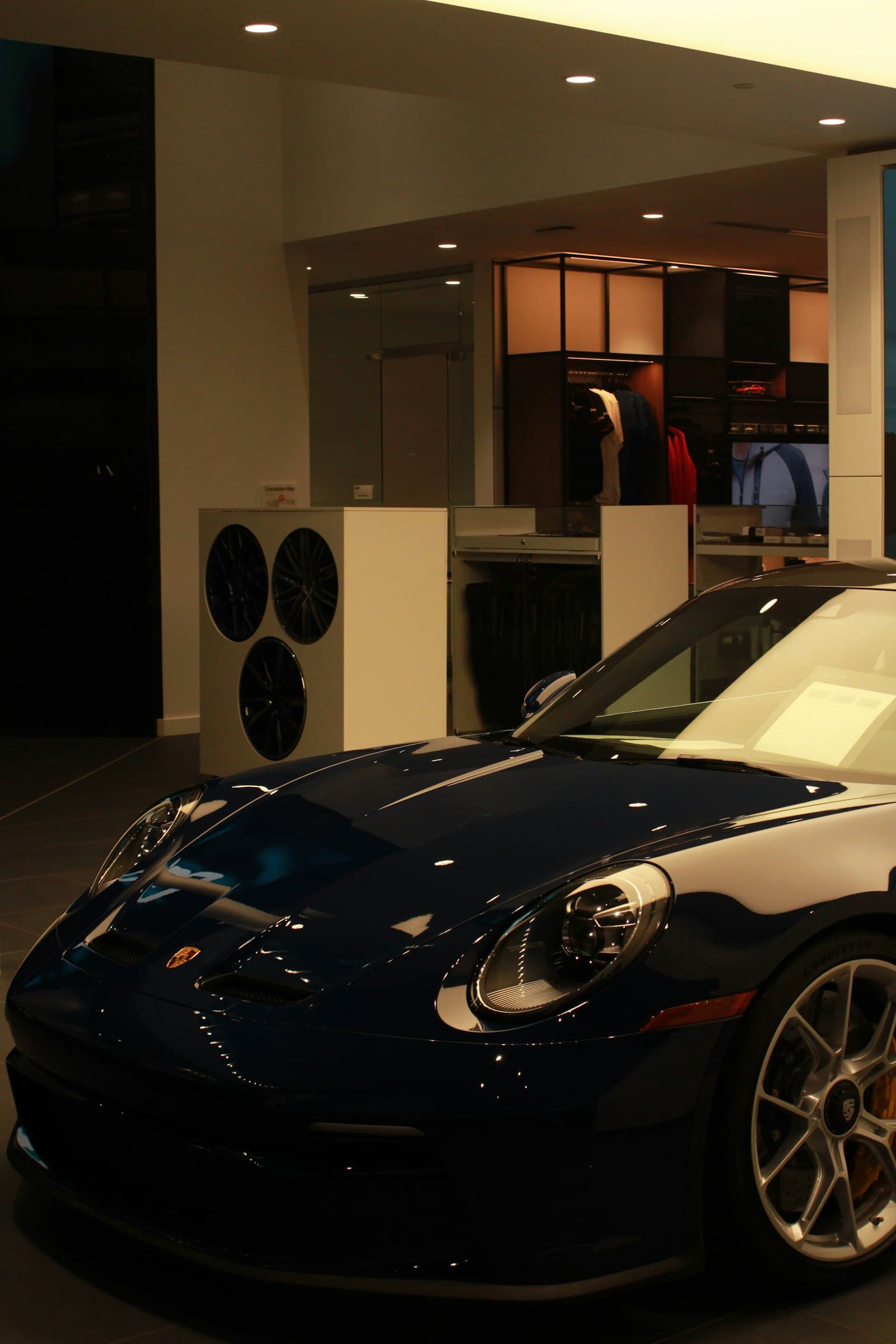 Dark blue Porsche 911 inside a showroom