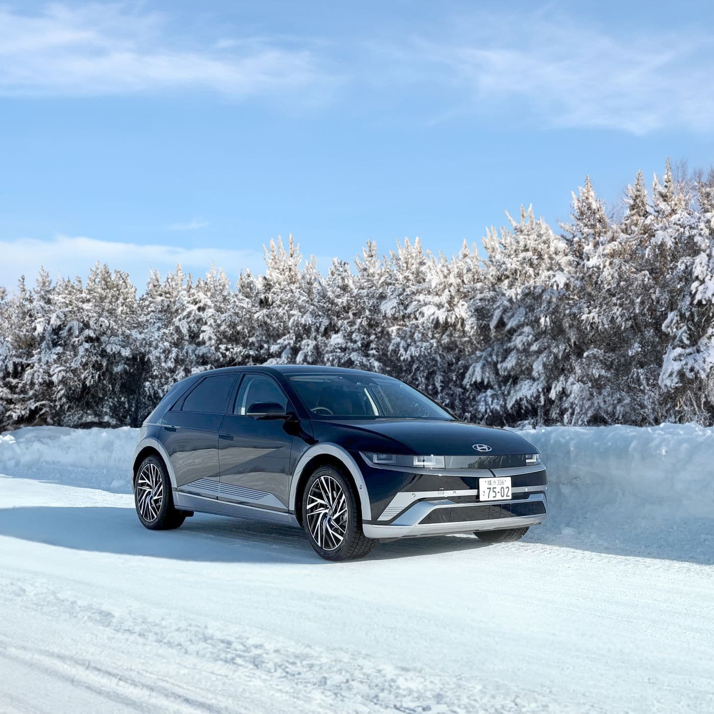 Dark Hyundai Ioniq 5 on a snowy road