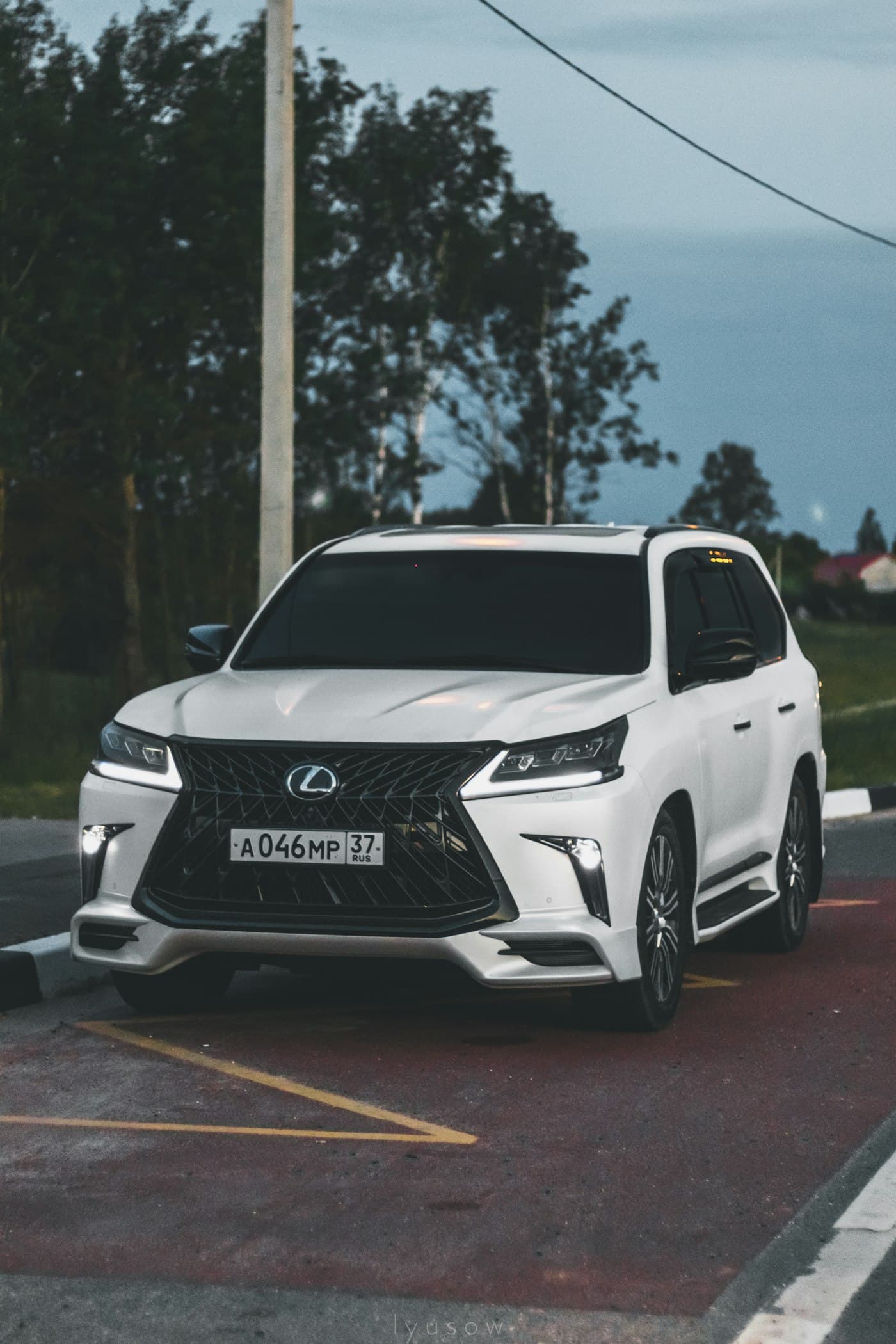 White Lexus LX parked at dusk