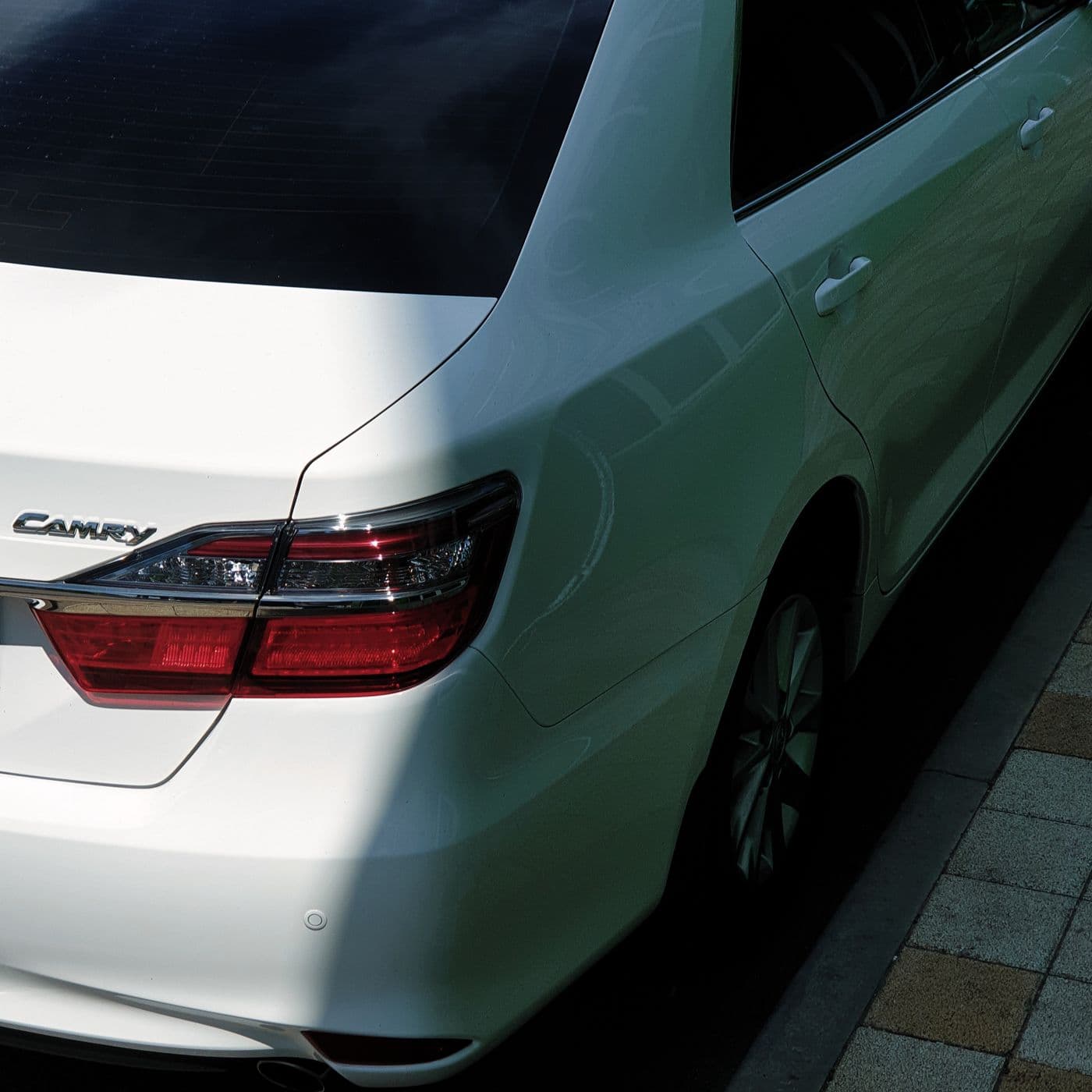Rear view of a white Toyota Camry — representative image
