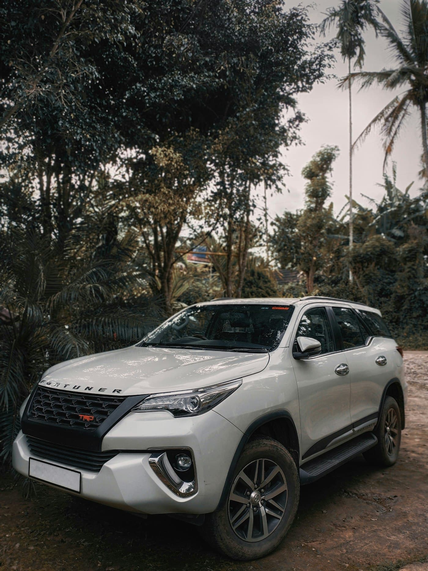 White Toyota Fortuner on a dirt road